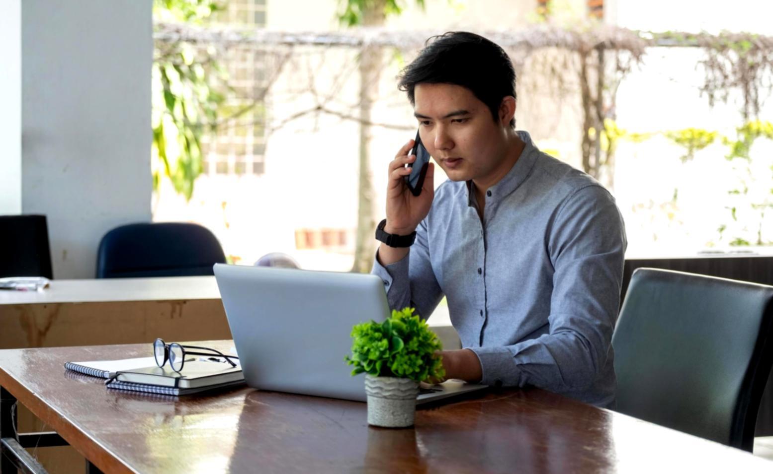 Corporate finance analyst reviewing investment reports and financial statements